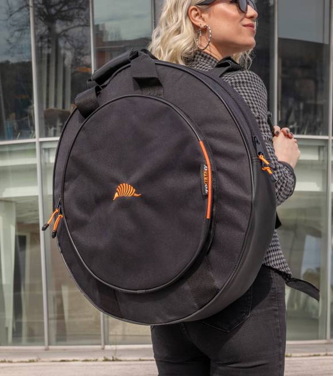 A drummer carrying their cymbals in a TOBAGO gigbag