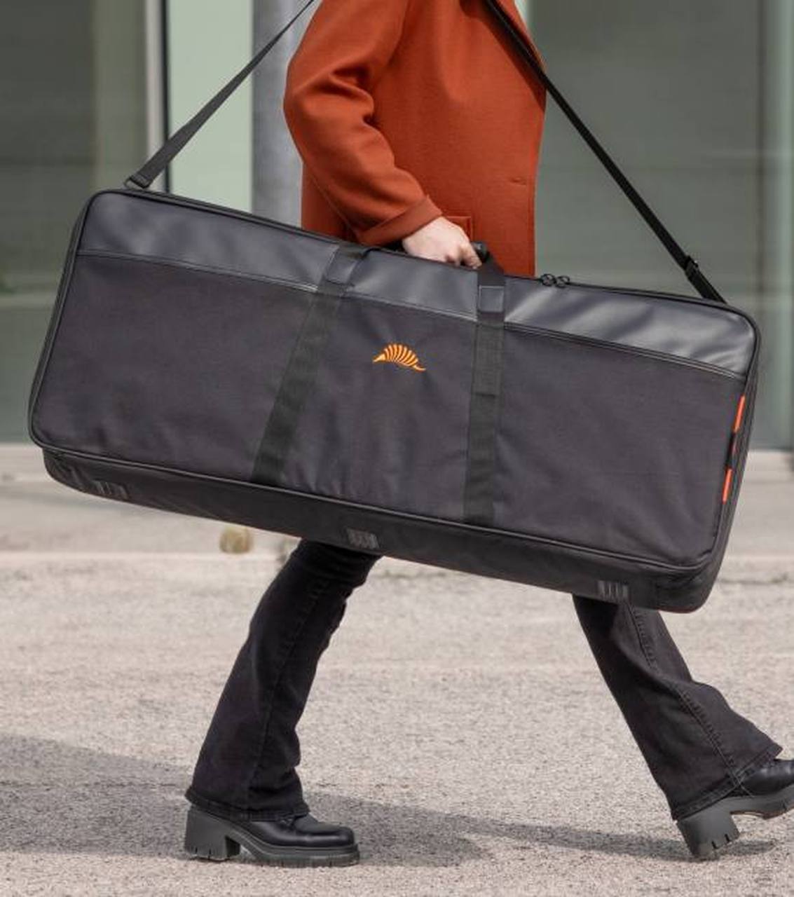 A keyboard player carrying their keyboard in a TOBAGO semi-rigid case, heading to band reharsal.